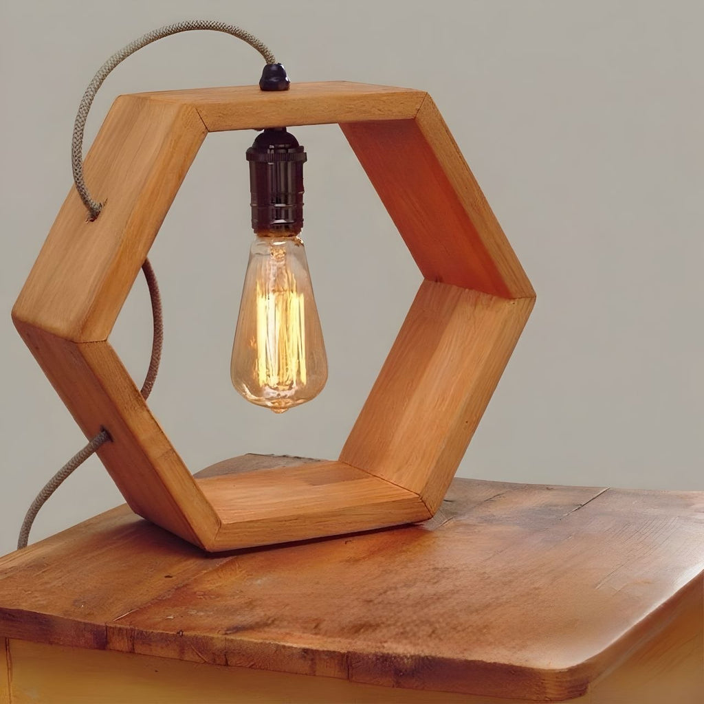 Hexagonal wood frame table lamp with Edison bulb.